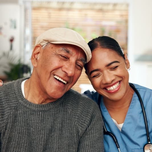 Caregiver and client sharing a joyful moment